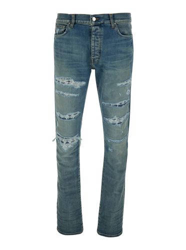 Blue ma Quand Jeans With Ripped Details On The Front And Logo Patch On The Rear In Denim Man - AMIRI - Modalova