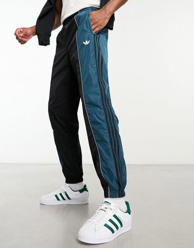 Rekive - Pantaloni sportivi neri e blu con inserto in rete - adidas Originals - Modalova