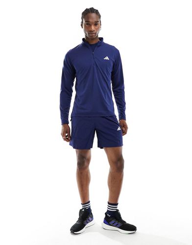 Adidas Training - Essentials - Top blu navy con zip corta - adidas performance - Modalova