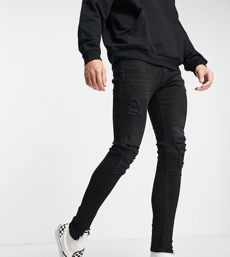 Jeans skinny effetto spray on nero slavato con strappi vistosi - ADPT - Modalova