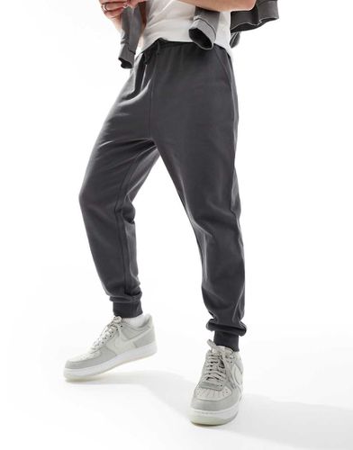 Essential - Joggers affusolati nero slavato - ASOS DESIGN - Modalova