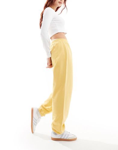 Joggers in felpa gialli con polsino - ASOS DESIGN - Modalova