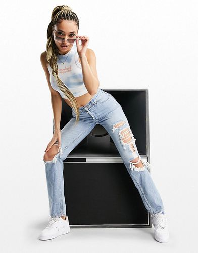 Jeans dritti a vita medio alta stile anni '90 in lavaggio chiaro con strappi vistosi - ASOS DESIGN - Modalova