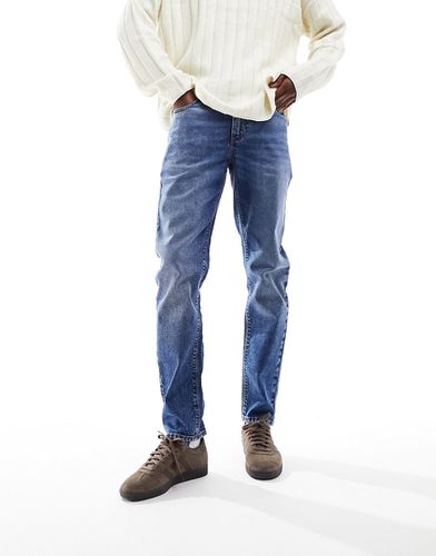Jeans elasticizzati affusolati lavaggio scuro - ASOS DESIGN - Modalova