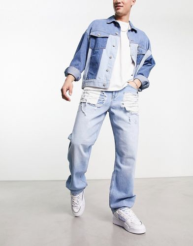 Jeans larghi lavaggio chiaro con strappi vistosi - ASOS DESIGN - Modalova