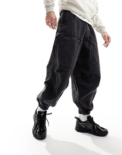 Jeans slavato stile paracadutista con zip - ASOS DESIGN - Modalova