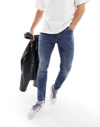 Jeans skinny lavaggio medio con dettagli effetto vernice - ASOS DESIGN - Modalova