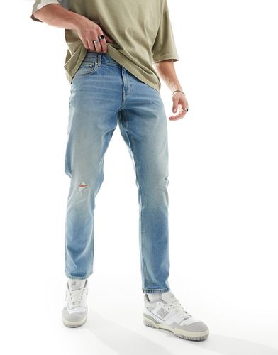 Jeans slim elasticizzati lavaggio chiaro con abrasioni - ASOS DESIGN - Modalova