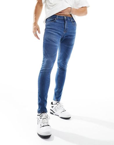 Jeans spray on super elasticizzati lavaggio scuro vintage - ASOS DESIGN - Modalova