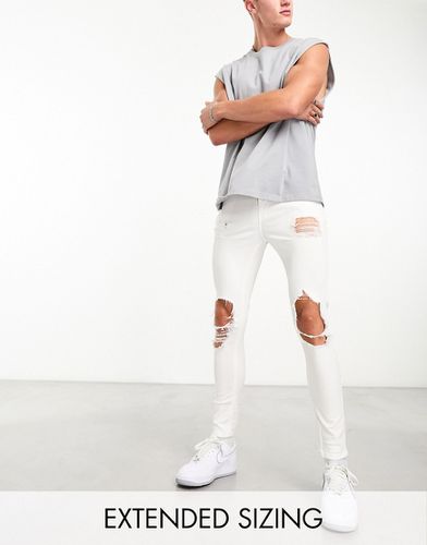 Jeans spray on power stretch bianchi con strappi vistosi - ASOS DESIGN - Modalova