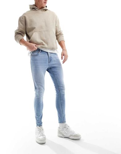 Jeans spray on power stretch lavaggio chiaro - ASOS DESIGN - Modalova