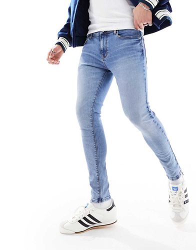 Jeans spray on power stretch lavaggio chiaro - ASOS DESIGN - Modalova