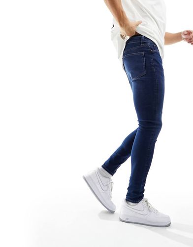 Jeans spray power-stretch lavaggio scuro - ASOS DESIGN - Modalova