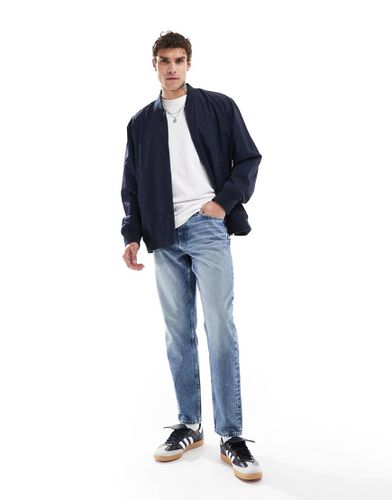 Jeans affusolati lavaggio medio - ASOS DESIGN - Modalova