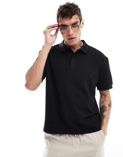 Polo nera comoda a coste larghe - ASOS DESIGN - Modalova