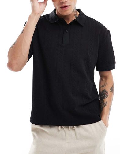 Polo nera comoda a coste larghe - ASOS DESIGN - Modalova