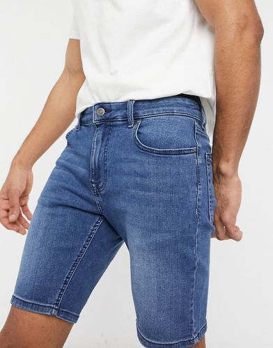 Pantaloncini di jeans power stretch con effetto spray on lavaggio scuro - ASOS DESIGN - Modalova