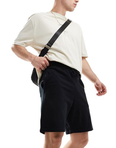 Pantaloncini slim di media lunghezza neri - ASOS DESIGN - Modalova