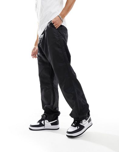 Pantaloni a fondo ampio in nylon neri in coordinato - ASOS DESIGN - Modalova