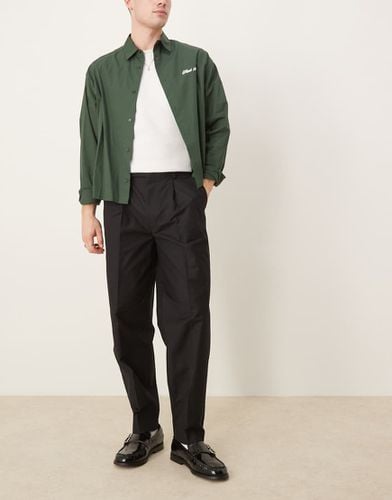 Pantaloni affusolati oversize eleganti neri manopesca con pieghe sul davanti - ASOS DESIGN - Modalova