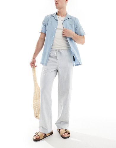 Pantaloni ampi blu e bianchi in seersucker a righe con elastico in vita - ASOS DESIGN - Modalova