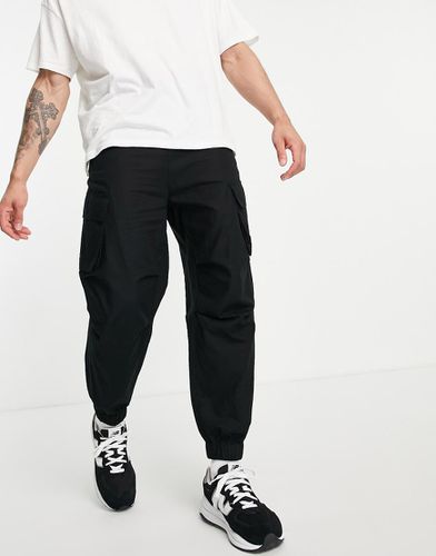 Pantaloni cargo affusolati neri - ASOS DESIGN - Modalova