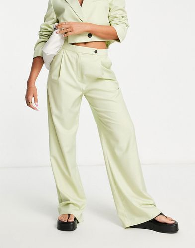 Pantaloni da abito extra larghi con fondo ampio color lime slavato - ASOS DESIGN - Modalova