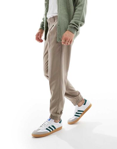 Pantaloni eleganti affusolati color pietra con fondo stile joggers - ASOS DESIGN - Modalova