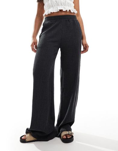 Pantaloni testurizzati a fondo ampio neri - ASOS DESIGN - Modalova