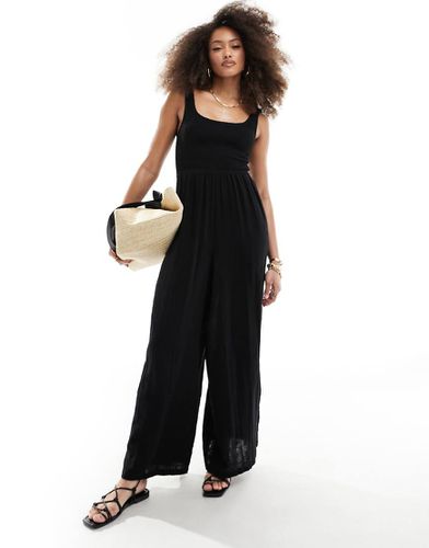 Tuta jumpsuit a fondo ampio con scollo rotondo nera - ASOS DESIGN - Modalova