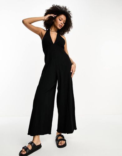 Tuta jumpsuit allacciata al collo in jersey stropicciato nera - ASOS DESIGN - Modalova