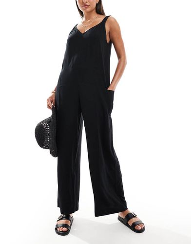 Tuta jumpsuit da spiaggia nera con tasche - ASOS DESIGN - Modalova