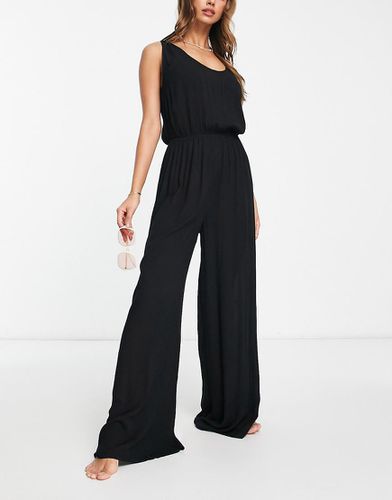 Tuta jumpsuit minimal da mare stropicciata a fondo ampio nera - ASOS DESIGN - Modalova