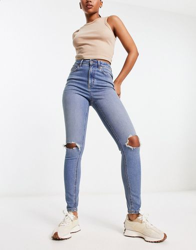 Ultimate - Jeans skinny medio con strappi sulle ginocchia - ASOS DESIGN - Modalova