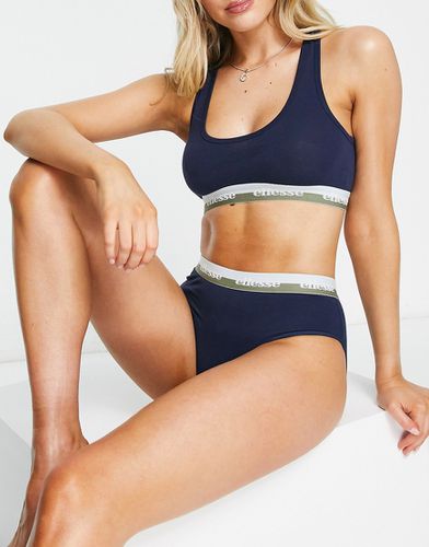 Completo con brassière a scollo rotondo e slip con fascette a righe - ellesse - Modalova