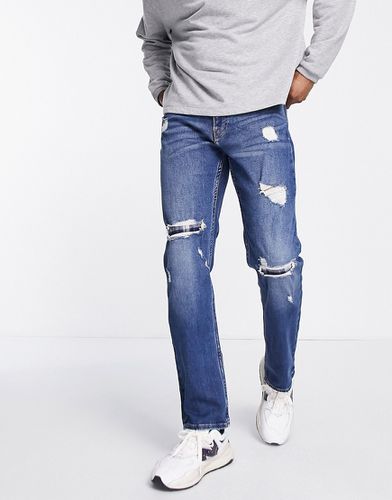 Jeans a gamba dritta slim lavaggio scuro effetto invecchiato con rammendi in flanella - Hollister - Modalova