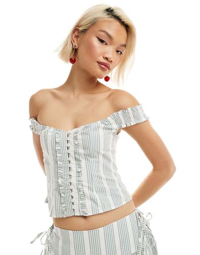 Top a corsetto blu a righe con volant - Motel - Modalova