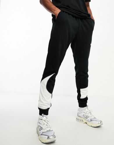 Dri-FIT Energy Swoosh - Joggers affusolati neri con logo - Nike Training - Modalova