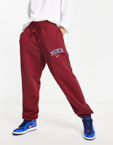 Phoenix - Joggers unisex in pile rossi stile college - Nike - Modalova