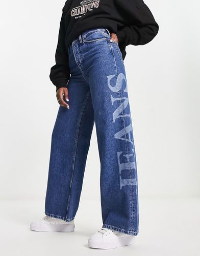 Jeans a fondo ampio lavaggio medio a vita alta con logo - Tommy Jeans - Modalova