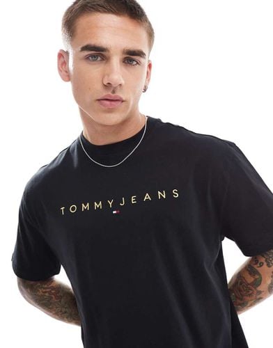 T-shirt nera con logo dorato lineare - Tommy Jeans - Modalova