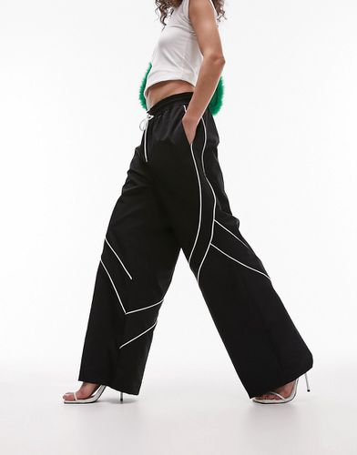 Pantaloni sportivi a fondo ampio in nylon neri con profili a contrasto - Topshop - Modalova