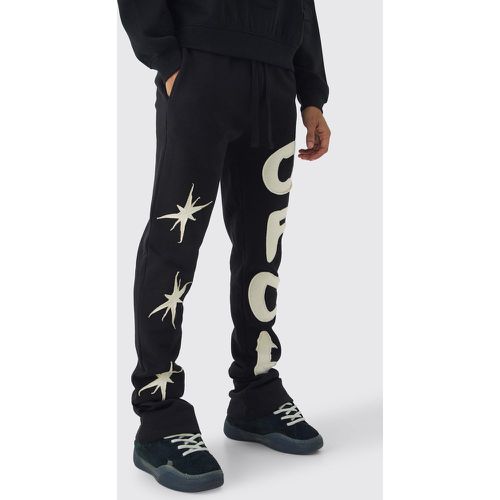 Pantaloni tuta Slim Fit con applique a stella e pieghe sul fondo - boohoo - Modalova