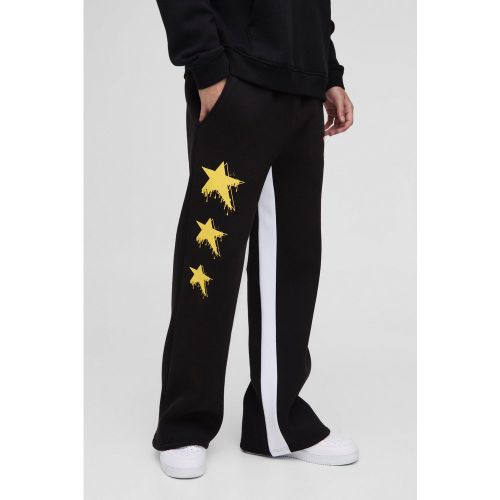 Pantaloni tuta rilassati a zampa con inserti a stella - boohoo - Modalova