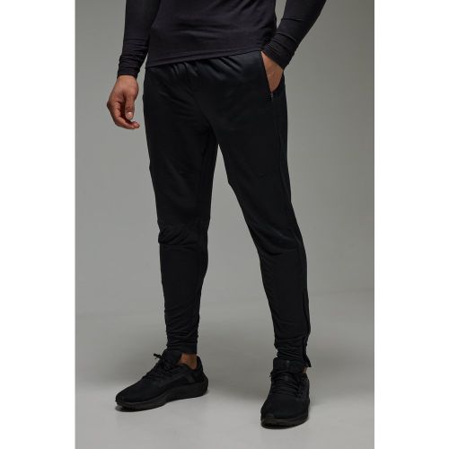 Pantaloni tuta affusolati Man Active Stretch con zip sul fondo - boohoo - Modalova