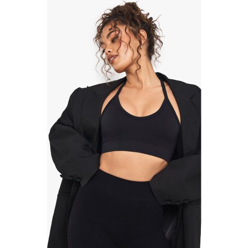 Reggiseno sportivo a coste senza cuciture con scollo profondo incrociato sul retro - boohoo - Modalova