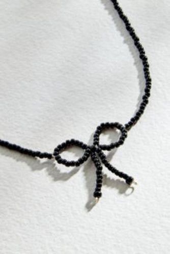 Glass Bead Bow Choker Necklace - Black at Urban Outfitters - Rhimani - Modalova