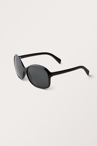 Große Ovale Sonnenbrille - Schwarz - Monki - Modalova